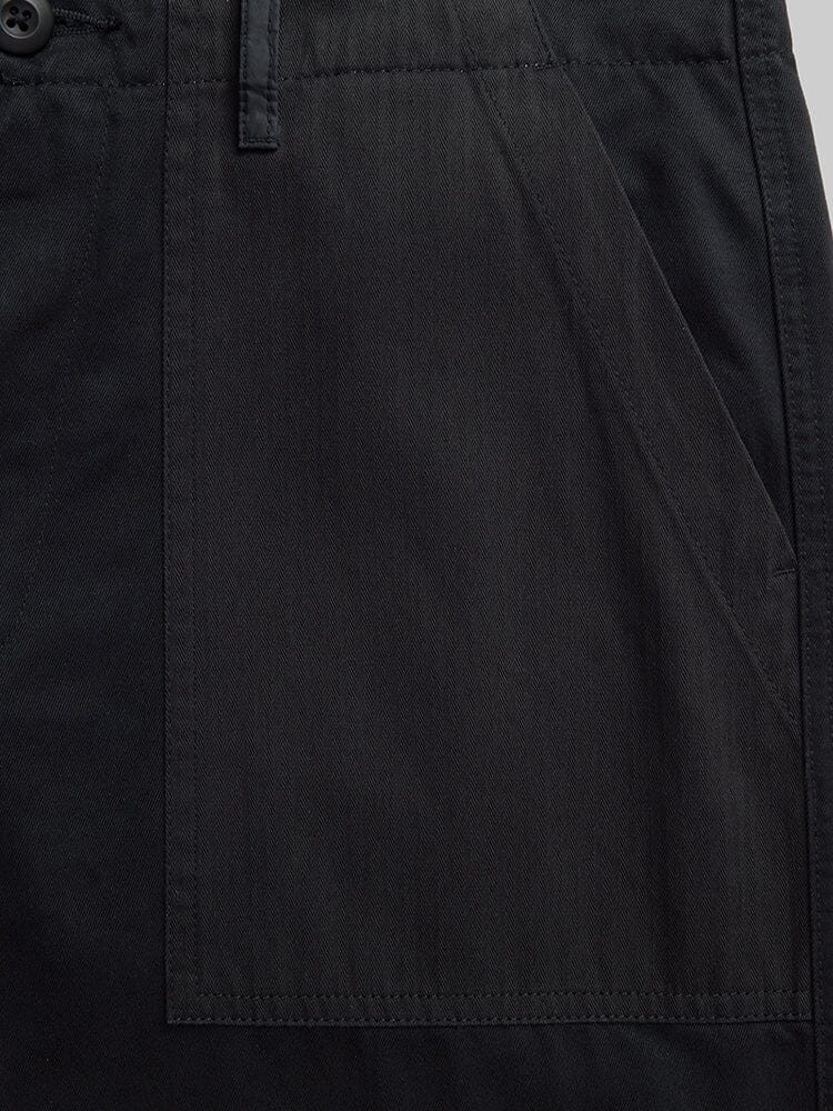 Alpha Industries Fatigue Pant in black cotton with large rectangular utility pocket, button detail, and waistband.