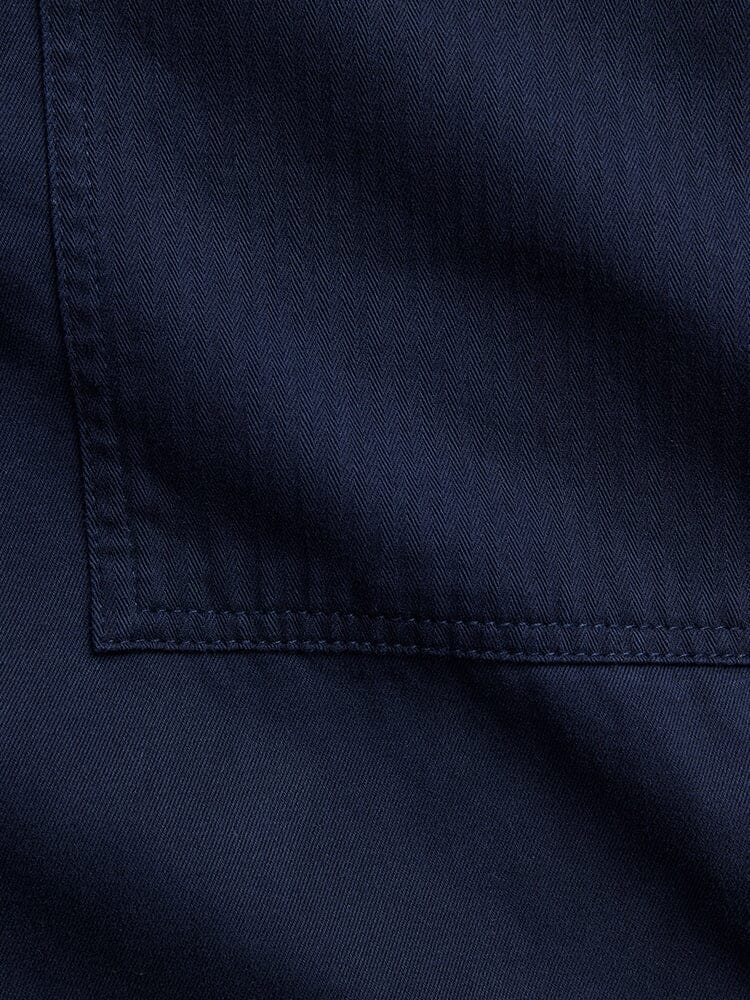 Alpha Industries Fatigue Pant, navy blue cotton, stitched utility pocket, herringbone pattern.