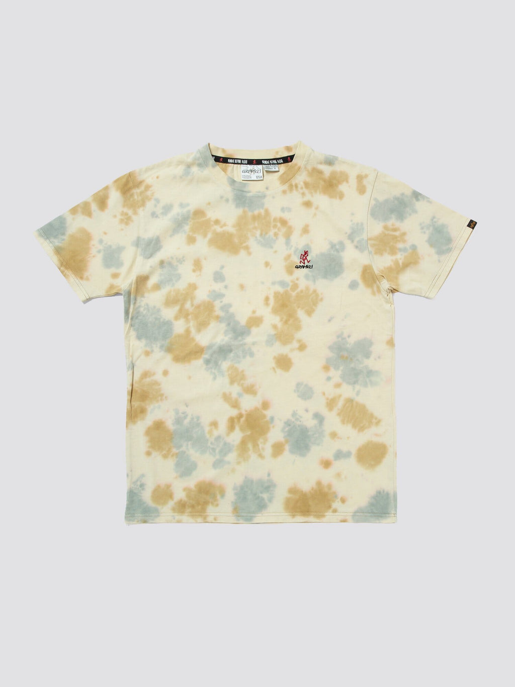 Gramicci X Alpha Cotton Camo Tie Dye Tee by Alpha Industries, cream cotton with blue and tan camo tie-dye spots and small Gramicci logo embroidered on left chest.