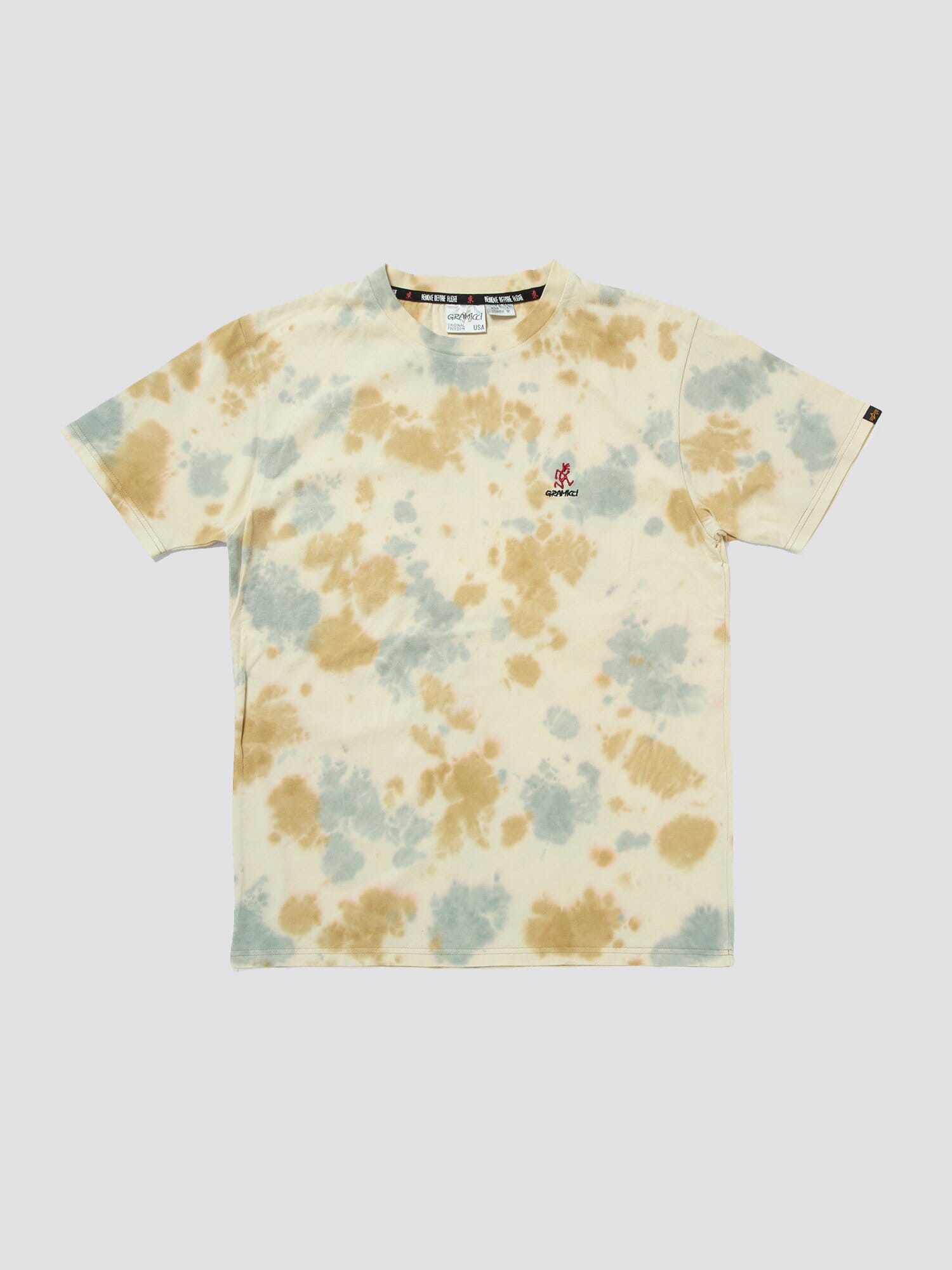 Gramicci X Alpha Cotton Camo Tie Dye Tee by Alpha Industries, cream cotton with blue and tan camo tie-dye spots and small Gramicci logo embroidered on left chest.