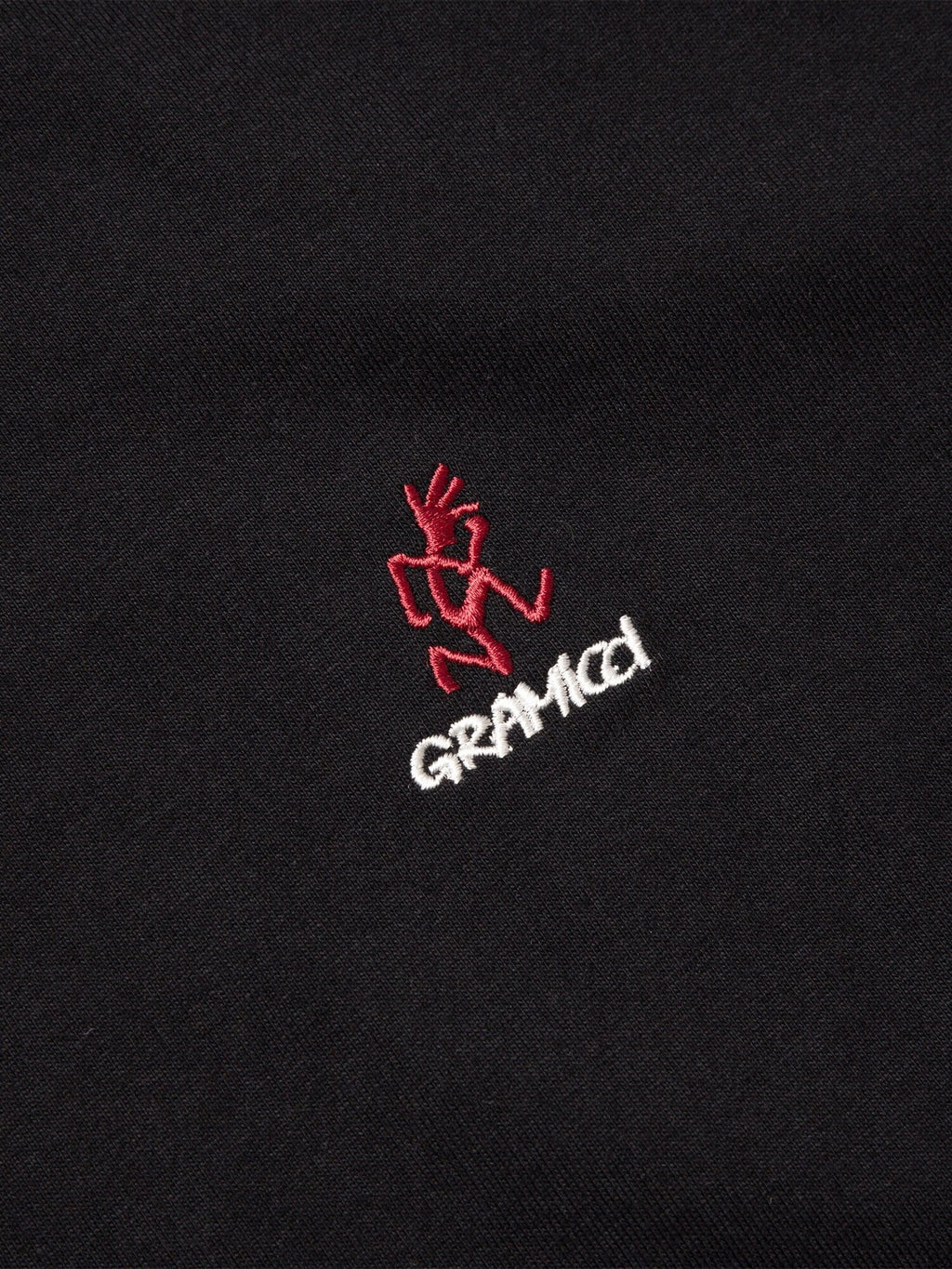 Alpha Industries Gramicci Cotton Cigar Pocket Tee, black, red embroidered figure above white Gramicci logo.