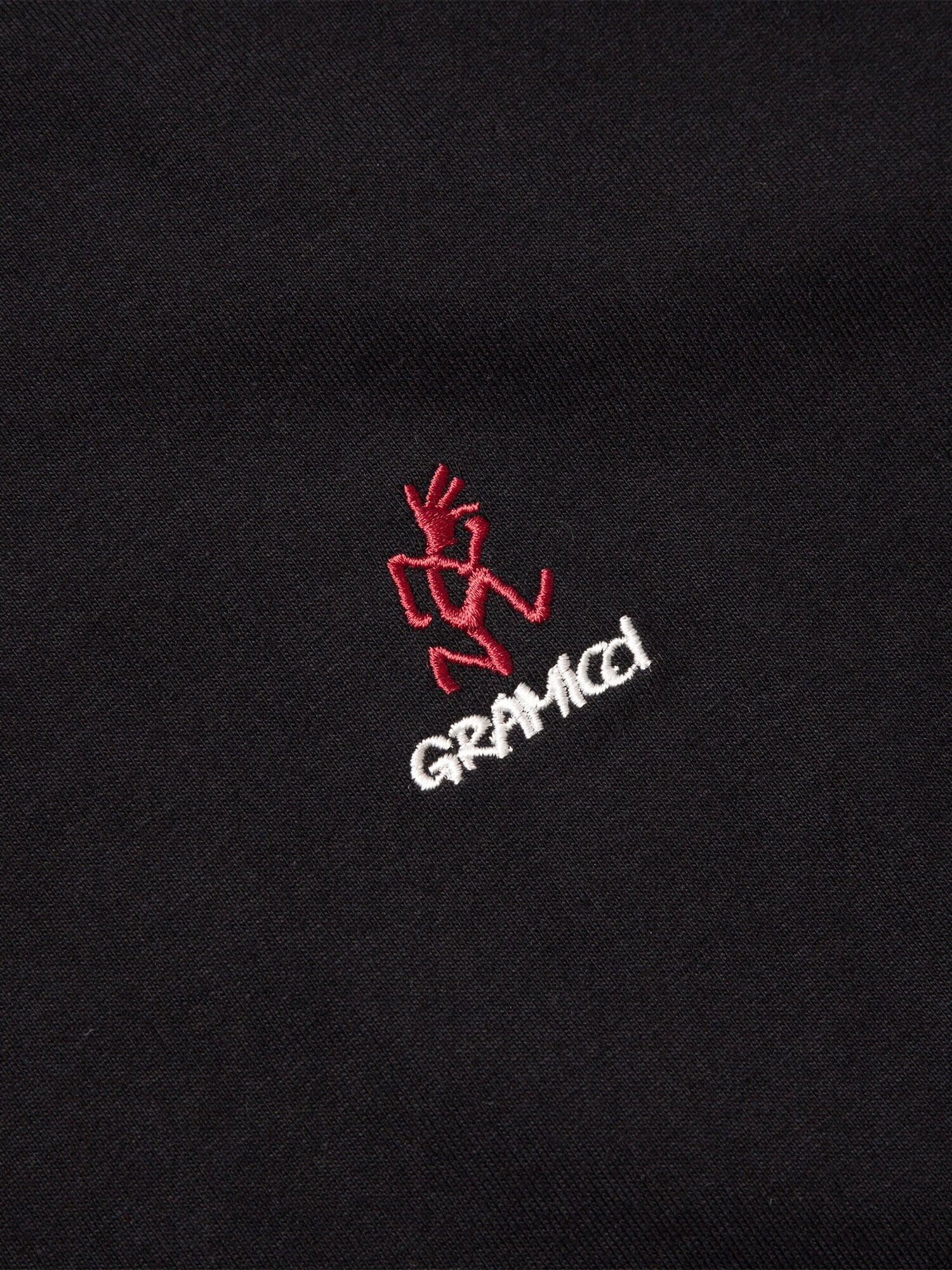 Alpha Industries Gramicci Cotton Cigar Pocket Tee, black, red embroidered figure above white Gramicci logo.