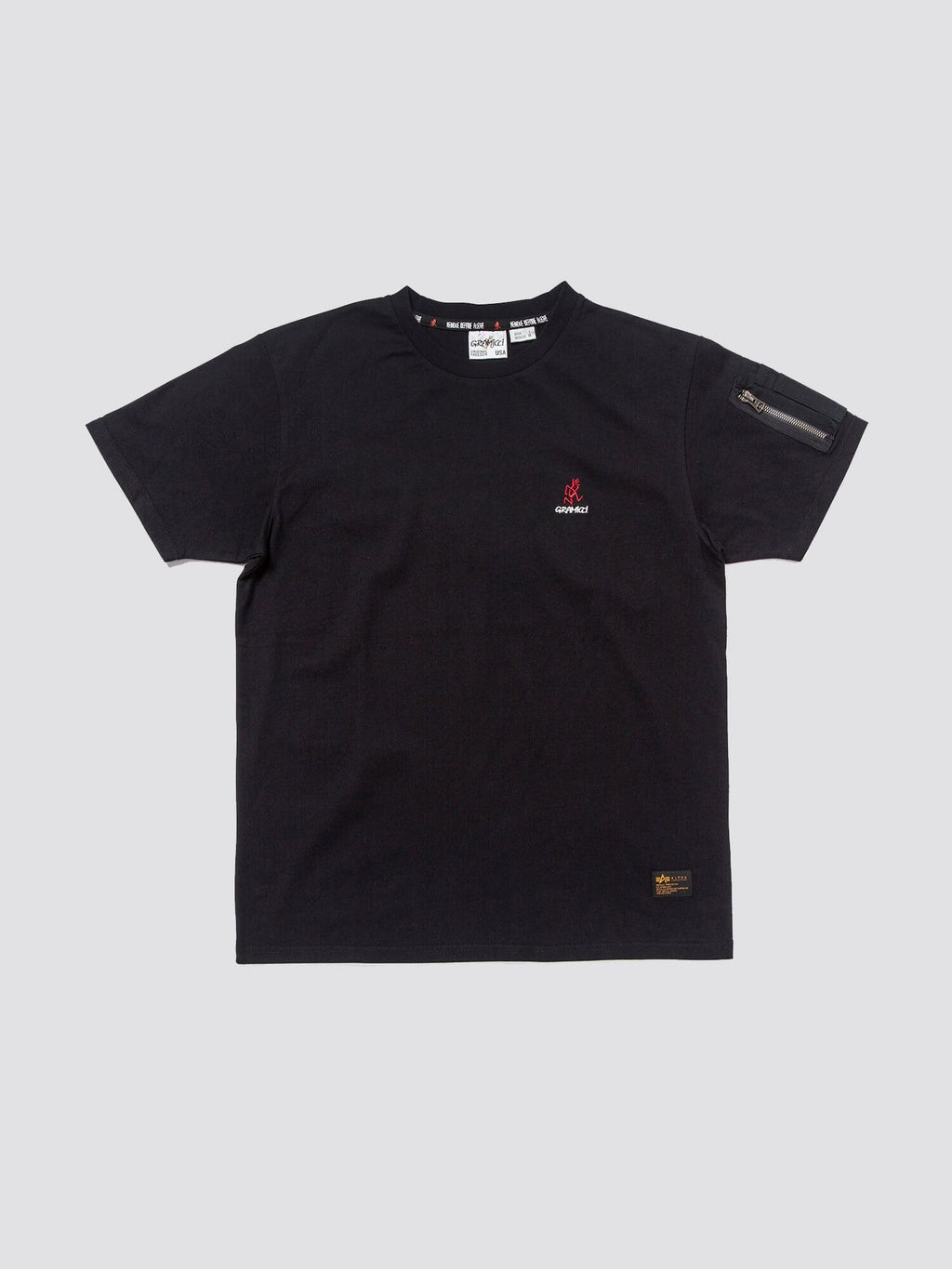 Gramicci X Alpha Cotton Cigar Pocket Tee by Alpha Industries, black cotton tee with small Gramicci logo on chest and zippered utility pocket on left sleeve.