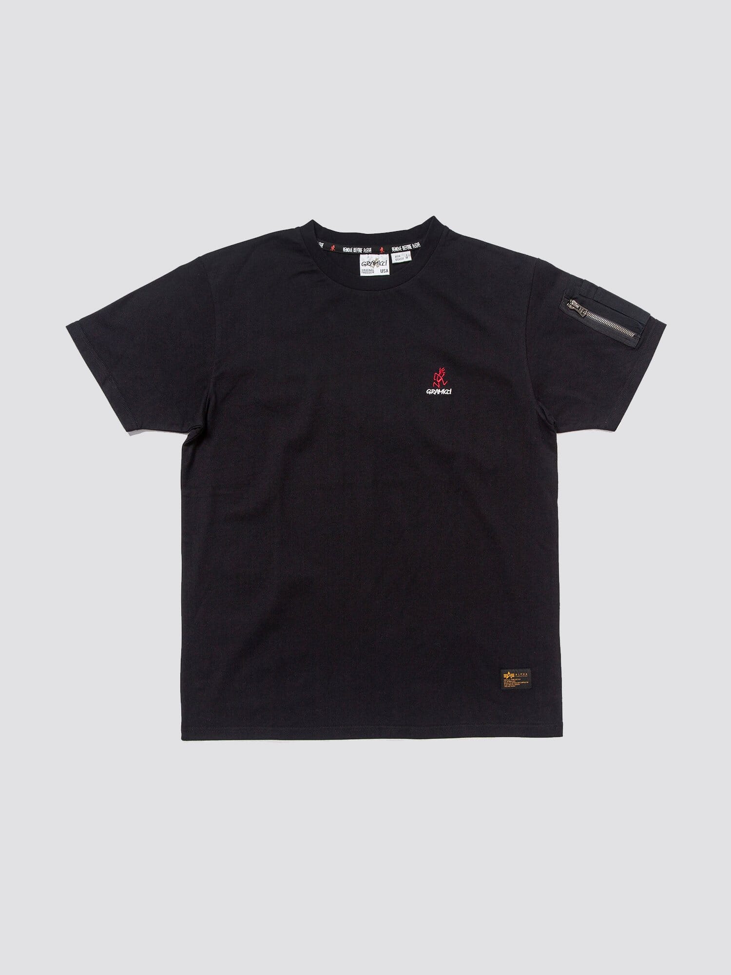Gramicci X Alpha Cotton Cigar Pocket Tee by Alpha Industries, black cotton tee with small Gramicci logo on chest and zippered utility pocket on left sleeve.