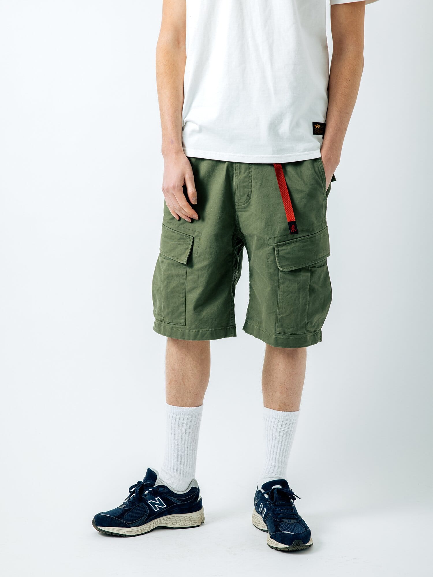 Gramicci X Alpha Jungle Cargo Short by Alpha Industries in olive with cargo pockets and red strap.