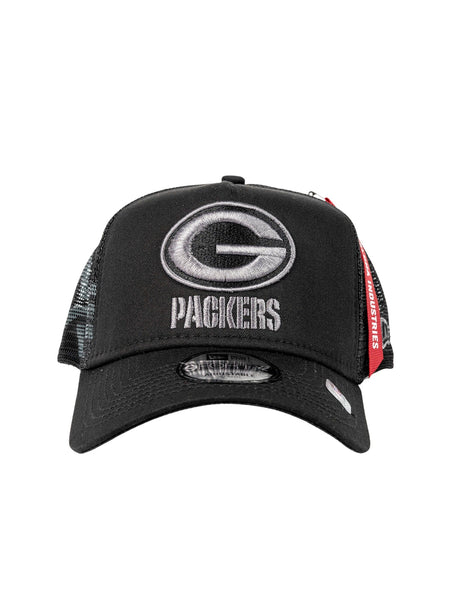 Green Bay Packers x Alpha Industries x New Era 940 Cap, featuring a black cap with a mesh back. The front is adorned with an embroidered stylized G and Packers text in the signature 9FORTY A-Frame Trucker design, complete with tags to proudly display your team spirit.