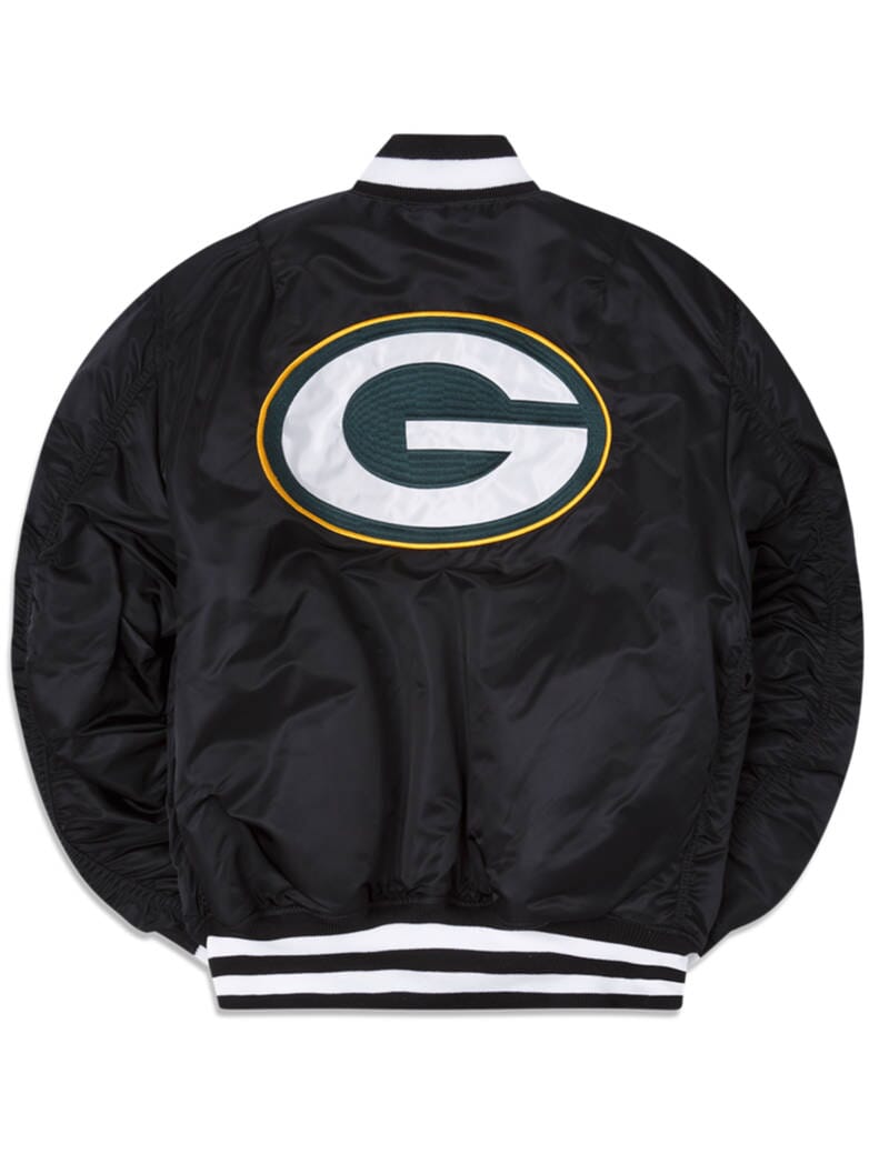 The Green Bay Packers X Alpha Industries X New Era MA-1 Bomber Jacket from Alpha Industries showcases a sleek black design with a large green and white G logo outlined in yellow on the back. It features sporty black and white striped cuffs and collar, highlighting the collaboration between New Era and NFL.