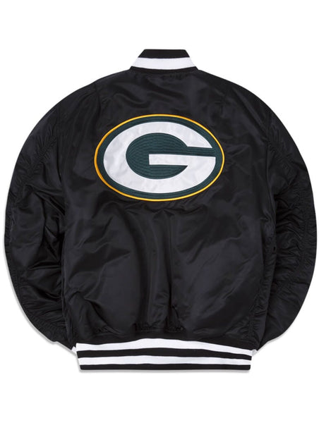 The Green Bay Packers X Alpha Industries X New Era MA-1 Bomber Jacket from Alpha Industries showcases a sleek black design with a large green and white G logo outlined in yellow on the back. It features sporty black and white striped cuffs and collar, highlighting the collaboration between New Era and NFL.