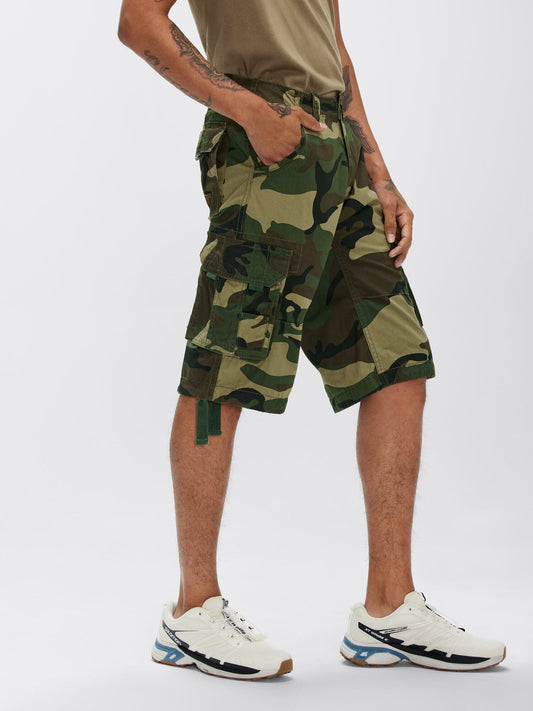 Alpha Industries Jet Short Camo in Woodland Camo, beige cotton t-shirt, white sneakers.