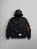 Introducing the L-2B Hooded Gen II Bomber Jacket from Alpha Industries, Inc., a stylish black bomber jacket made of water-resistant nylon. It boasts convenient front pockets and a bold visible red tag on the sleeve.