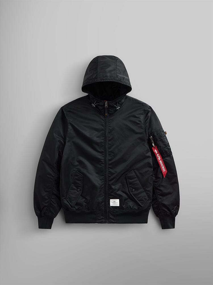 Introducing the L-2B Hooded Gen II Bomber Jacket from Alpha Industries, Inc., a stylish black bomber jacket made of water-resistant nylon. It boasts convenient front pockets and a bold visible red tag on the sleeve.