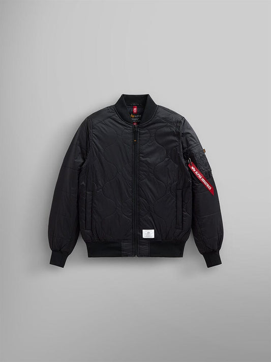 Alpha Industries L-2B Quilted Bomber Jacket in black with onion quilted details, front zipper, ribbed cuffs and collar, red Remove Before Flight sleeve tag, and white patch near hem.