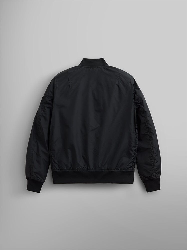 The L-2B Skymaster Gen II Bomber Jacket W by Alpha Industries, Inc. is a black bomber jacket made from lightweight nylon. It features a minimalist design with discreet oxygen tab details. This water-resistant jacket offers an elegant blend of style and functionality.