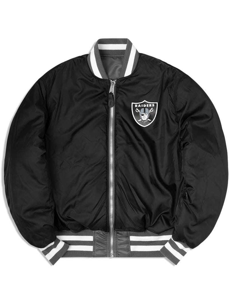 The Las Vegas Raiders X Alpha x New Era MA-1 Bomber Jacket by Alpha Industries and NE-NFL features a Raiders logo on the chest, gray and white striped cuffs and collar, a front zipper, and NFL team patches. This stylish bomber jacket is also water-resistant, making it perfect for any weather.