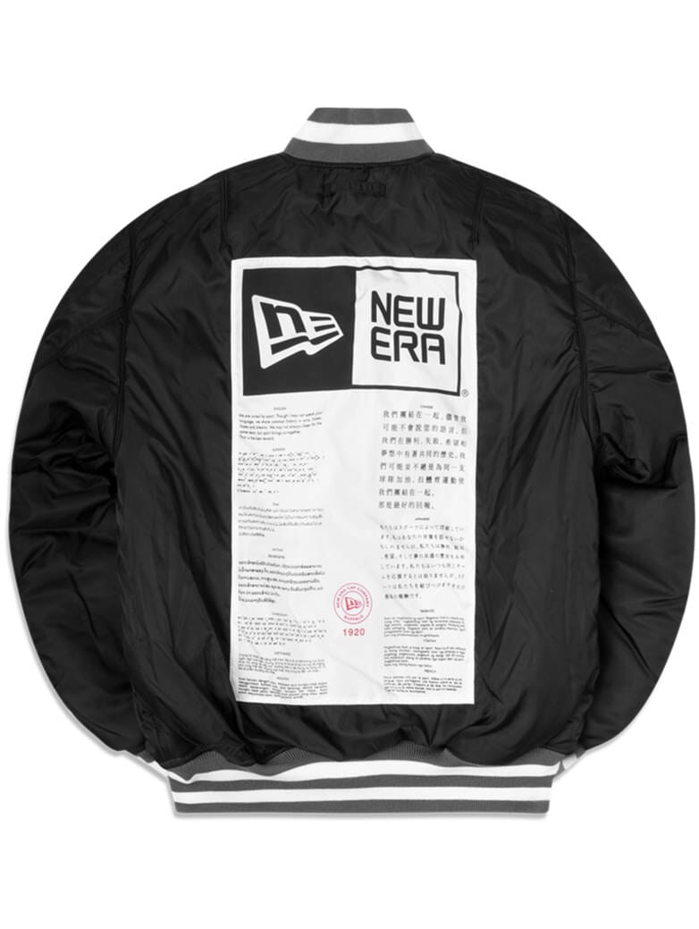 Introducing the Las Vegas Raiders x Alpha x New Era MA-1 Bomber Jacket by Alpha Industries. This sleek black bomber jacket showcases a large label design on the back, complete with text and logo. It's water-resistant and adorned with NFL team patches for a sporty touch.