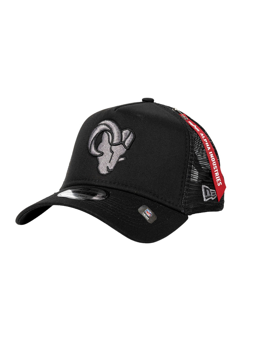 This black cap, from Alpha Industries and NE-NFL, features a distinctive ram logo on the front and a red tag on the side. Its design includes a mesh back and an adjustable strap, seamlessly blending comfort with iconic style.