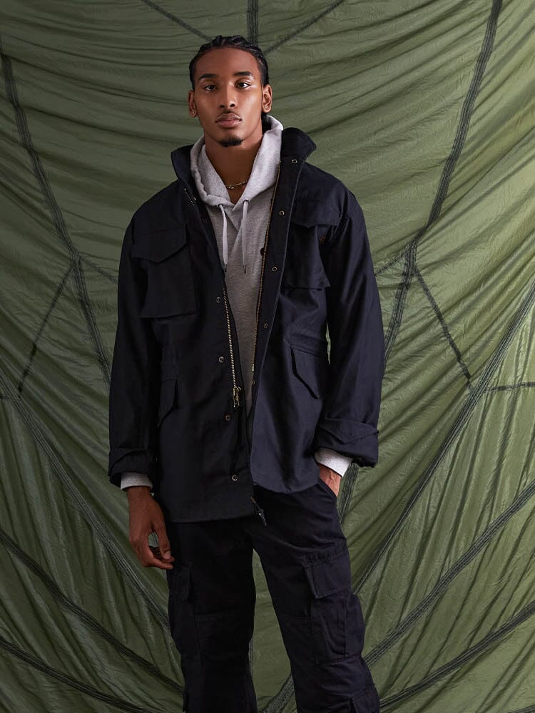 Alpha Industries M-65 Field Jacket in black, featuring cotton material and front zipper closure.
