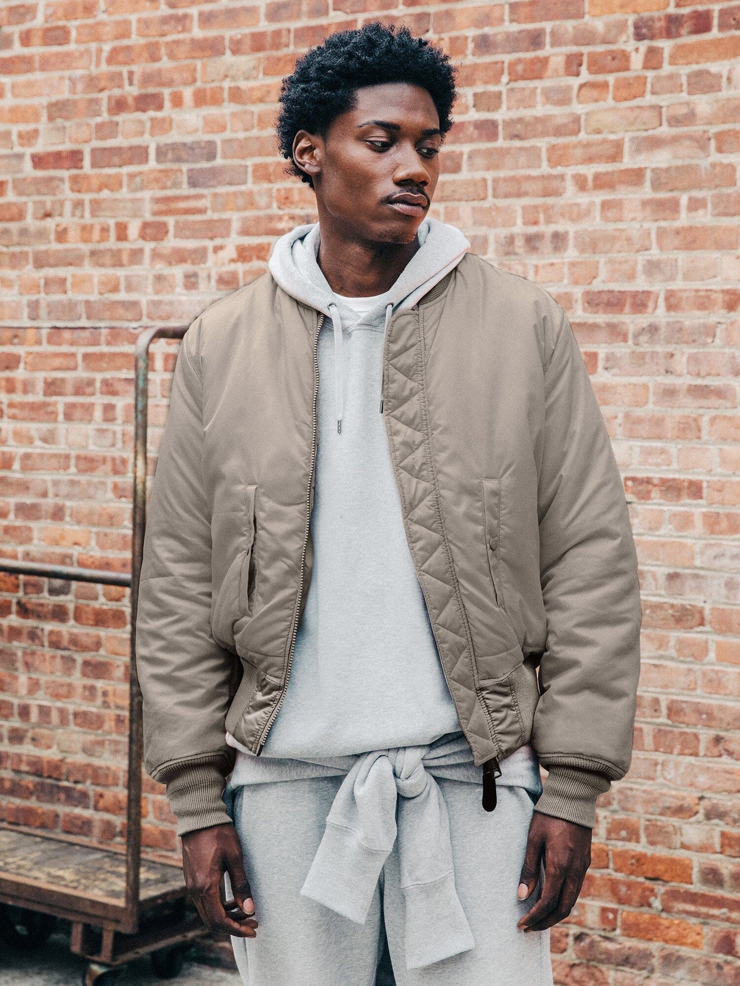Front view of MA-1 Bomber Jacket (Heritage) in Gray with male model. Knees up view. By Alpha Industries.