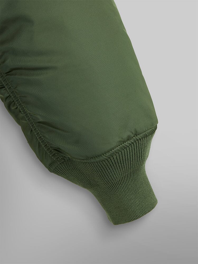 MA-1 Bomber Jacket by Alpha Industries in olive green with flight nylon sleeve and ribbed knit cuff.