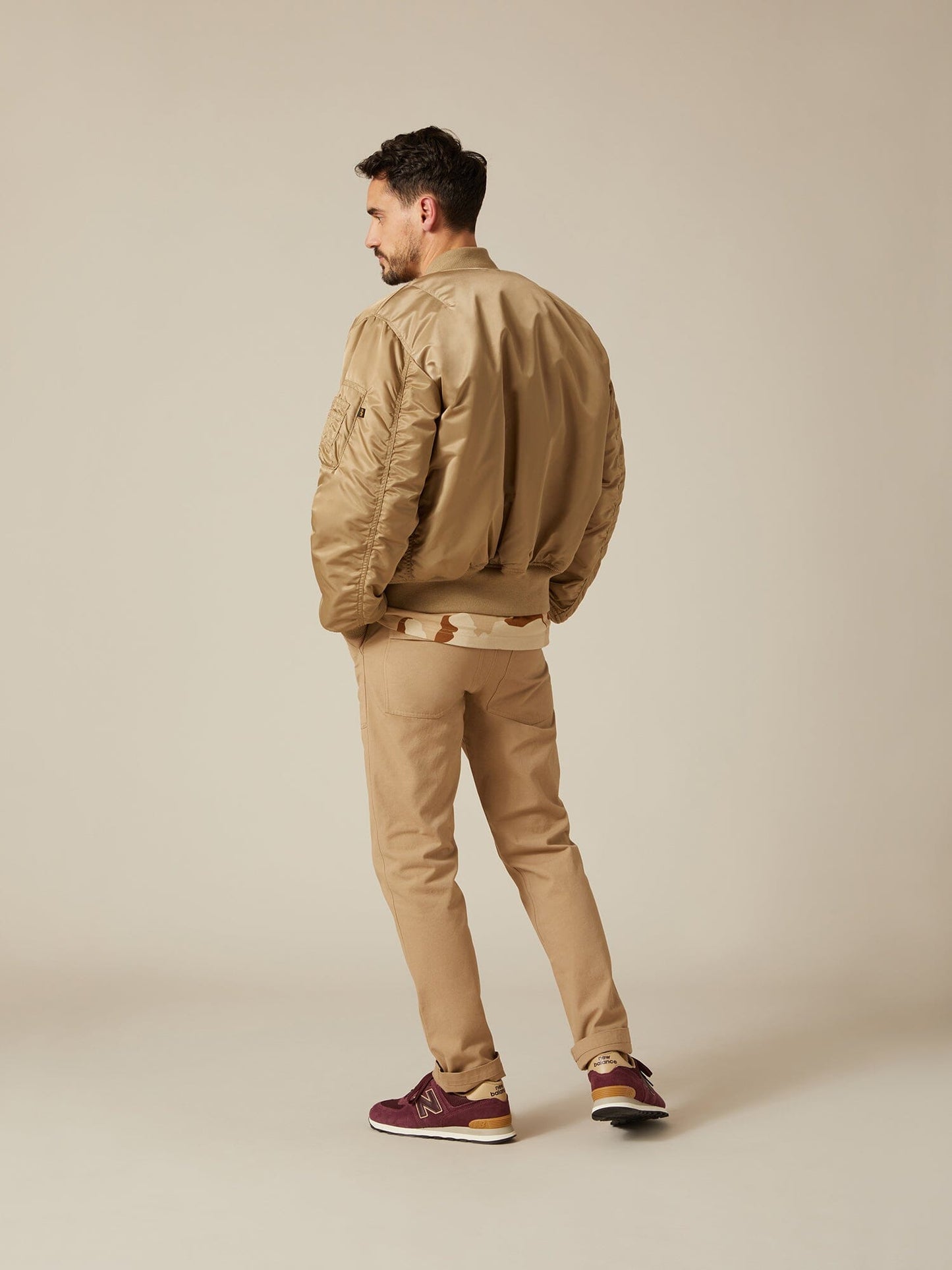 Back view of MA-1 Bomber Jacket (Heritage) in Khaki (Vintage) with male model. Angled view. By Alpha Industries.