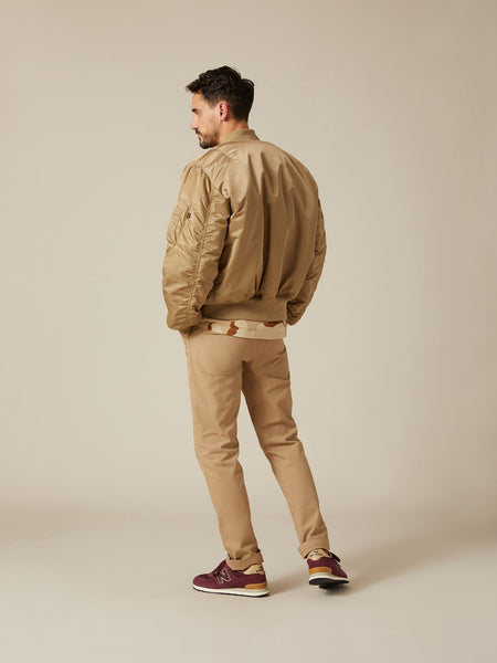 Back view of MA-1 Bomber Jacket (Heritage) in Khaki (Vintage) with male model. Angled view. By Alpha Industries.