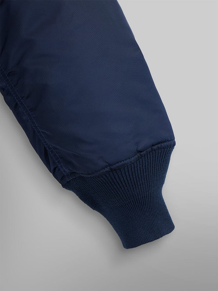 MA-1 Bomber Jacket by Alpha Industries with navy blue flight nylon sleeve and ribbed knit cuff.