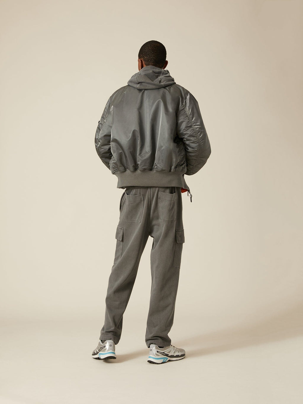 Alpha Industries MA-1 Bomber Jacket in gray flight nylon with matching cargo pants, hoodie, and sneakers.