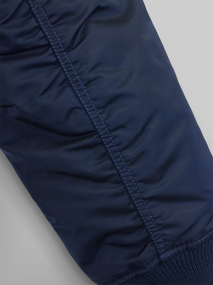Close up view of MA-1 Bomber Jacket (Heritage) in Dark Blue (Replica Blue). Sleeve stiching. By Alpha Industries.
