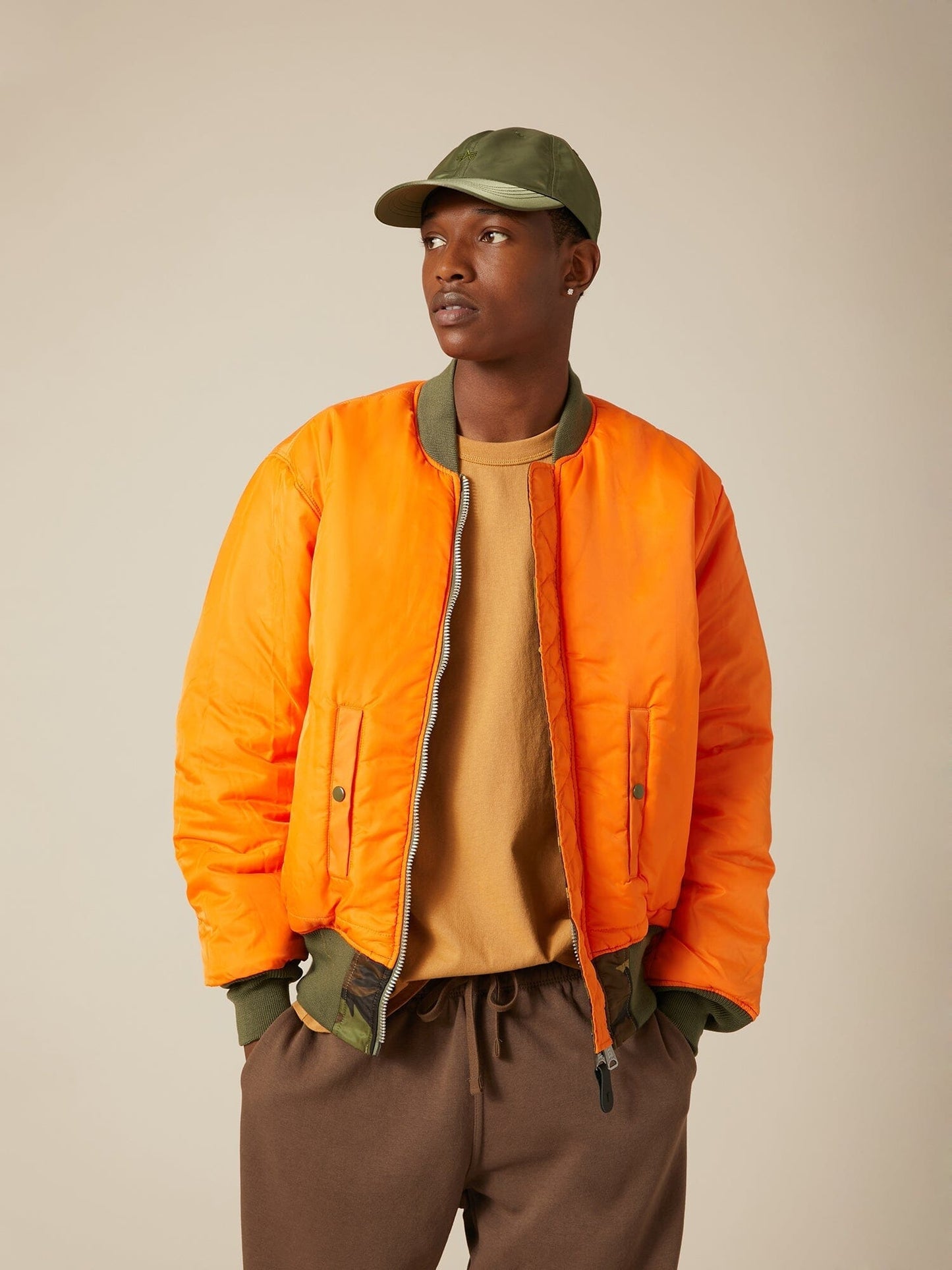 Front view of MA-1 Bomber Jacket (Heritage) in Woodland Camo with male model. Reversed view (Orange). By Alpha Industries.