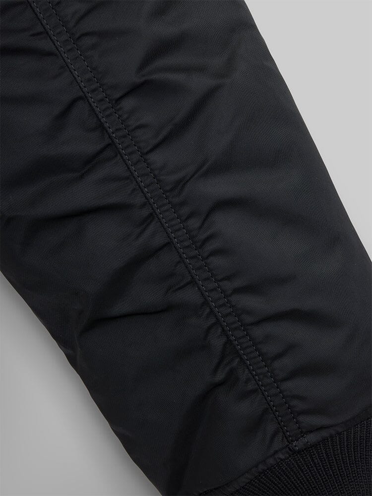 Close up view of MA-1 Bomber Jacket (Heritage) in Black. Sleeve stiching. By Alpha Industries.