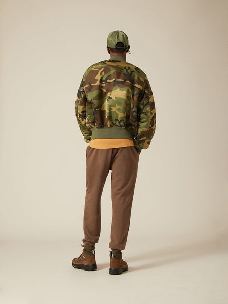 Back view of MA-1 Bomber Jacket (Heritage) in Woodland Camo with male model. Full body view. By Alpha Industries.
