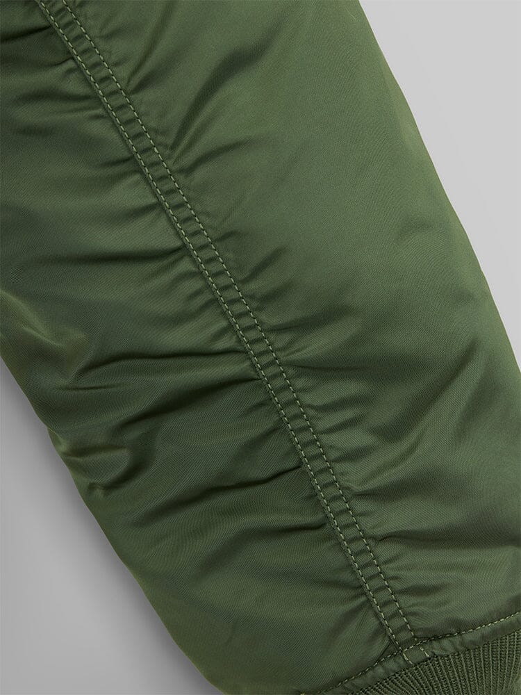 Green flight nylon sleeve with visible stitching and ruched seam detail, inspired by MA-1 Bomber Jacket from Alpha Industries.