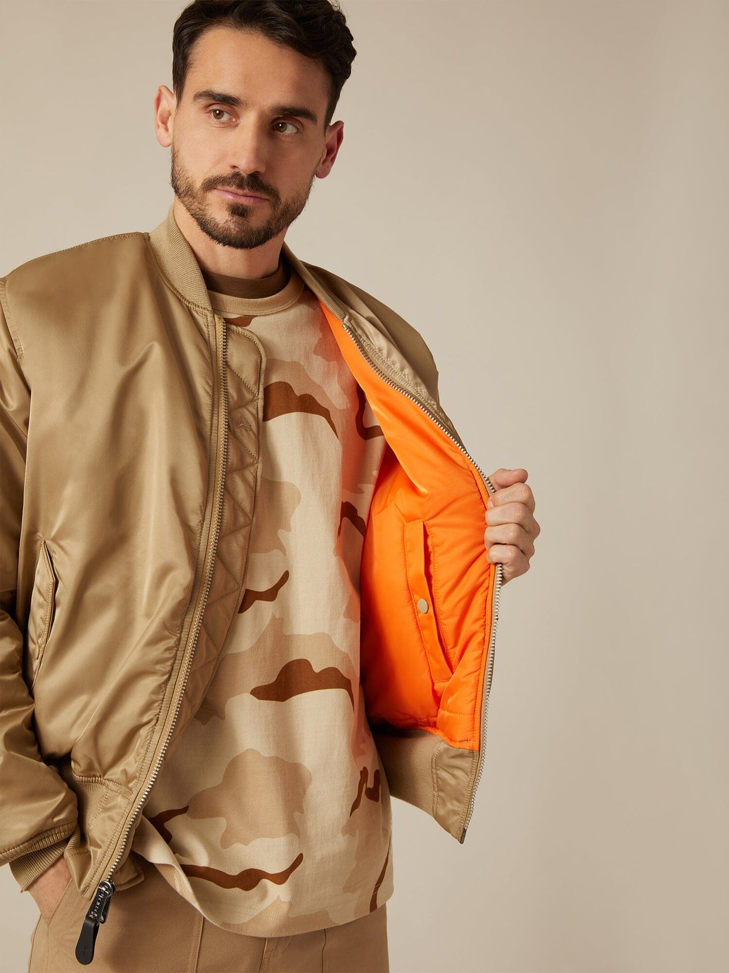 Front view of MA-1 Bomber Jacket (Heritage) in Khaki (Vintage) with male model. Front open view. By Alpha Industries.