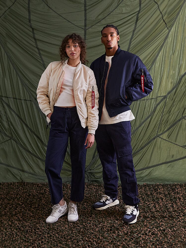 Alpha Industries MA-1 Bomber Jacket in flight nylon fabric, paired with white shirts, dark pants, and sneakers.
