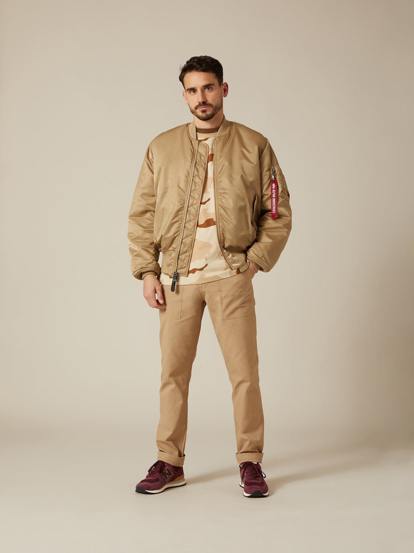 Front view of MA-1 Bomber Jacket (Heritage) in Khaki (Vintage) with male model. Full body view. By Alpha Industries.