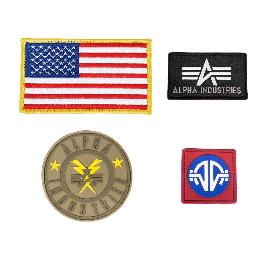 Alpha Industries MA-1 Flex Bomber Jacket with four patches: U.S. flag, black Alpha Industries logo, round yellow logo, and red-bordered patch.
