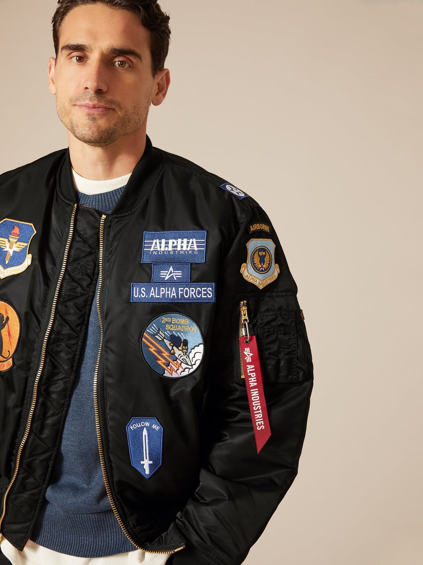 Alpha Industries MA-1 Squadron Bomber Jacket with assorted squadron patches and water resistance.
