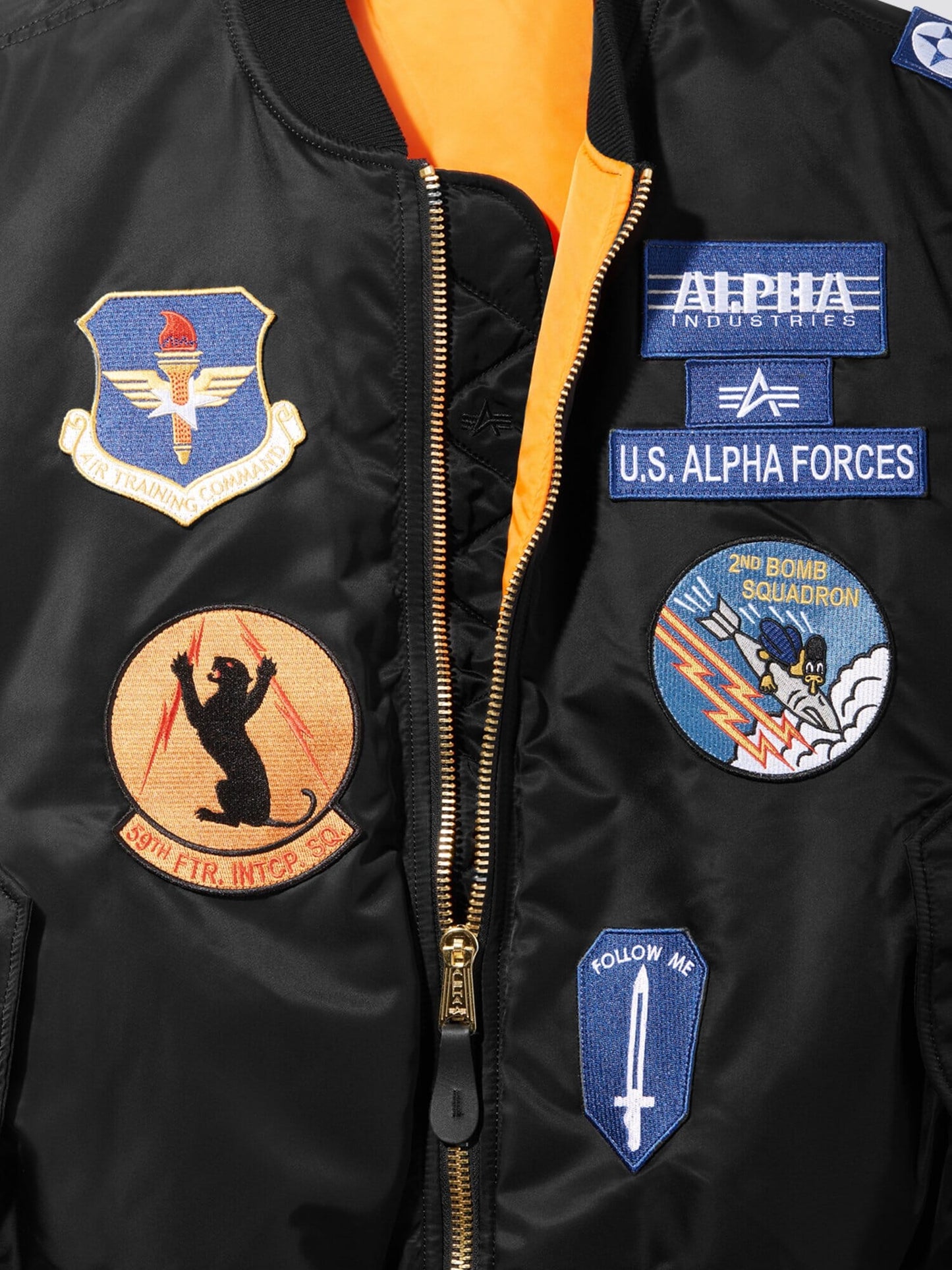 Alpha Industries MA-1 bomber jacket in black with water-resistant embroidered patches, including a bear silhouette.