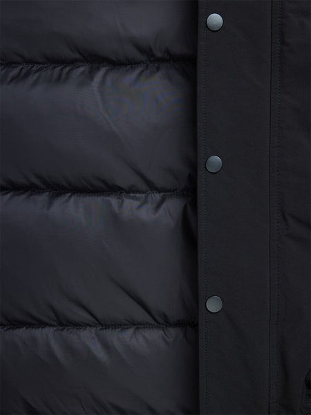 Close-up of a black padded N-2B Altitude Parka from Alpha Industries, featuring button snaps on the right edge and a water-resistant finish.