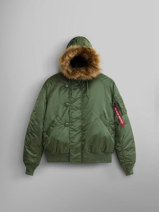 Alpha Industries N-2B Short Waist Parka in Sage: short waist bomber jacket with water repellent finish, faux mouton fur-lined hood, ribbed cuffs and hem, flap pockets, and red Remove Before Flight tag on left sleeve.