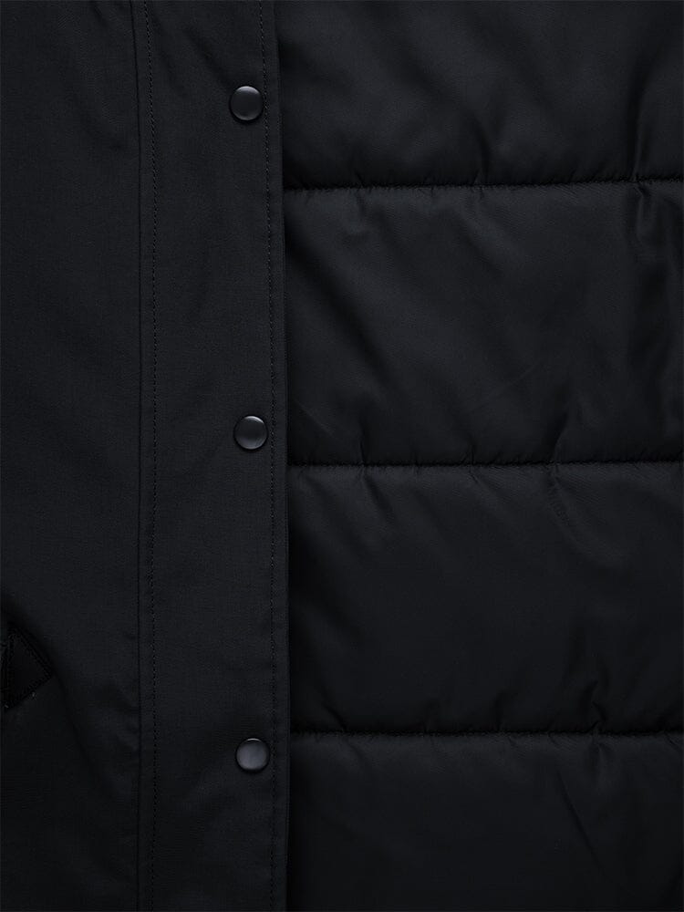 Close-up of the N-3B Altitude Mod Parka W by Alpha Industries, featuring a black padded design with a quilted pattern, snap buttons on the left side, and a snorkel hood for added protection.