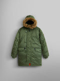 Alpha Industries N-3B Parka Youth in sage green with water resistance, fur-trimmed hood, button and zip closure, and two large front pockets.