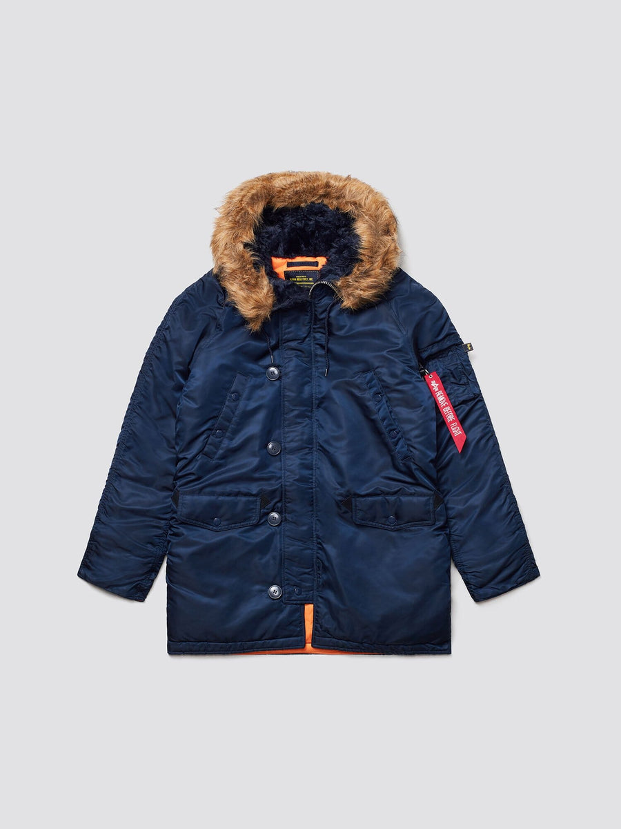 Alpha Industries N-3b Slim Gen I Parka, navy blue, faux fur-lined hood, water-resistant fabric, front button closure, two large front pockets, red tag on left sleeve.
