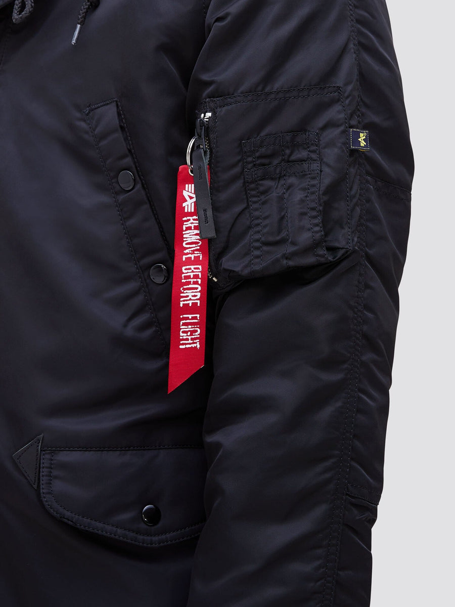 Alpha Industries N-3B Slim Gen I Parka black sleeve with zippered pocket, red Remove Before Flight tag, and water-resistant fabric.
