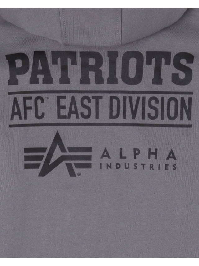 The New England Patriots x Alpha x New Era Hoodie by Alpha Industries is a gray hooded pullover with "PATRIOTS AFC East Division" and "Alpha Industries" text in black, showcasing the iconic Alpha Industries logo.