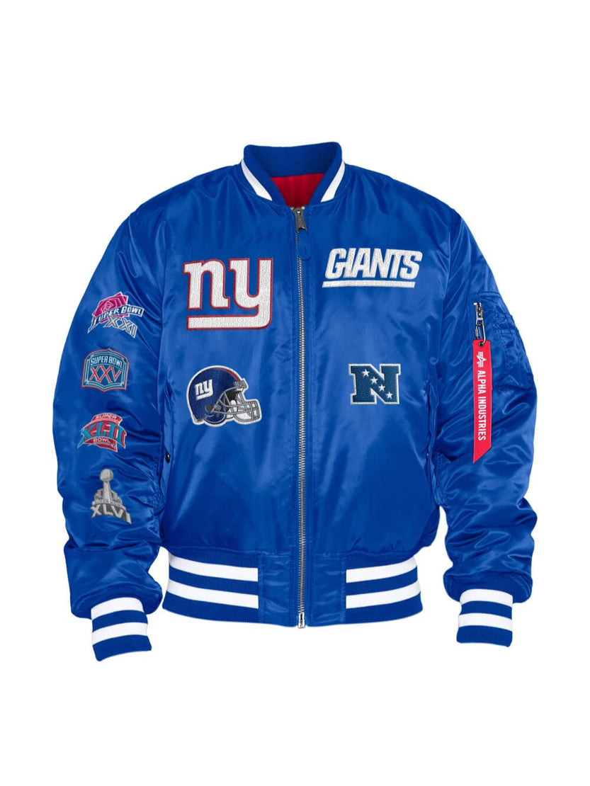 Reversible MA-1 bomber jacket called "New York Giants X Alpha X New Era" by Alpha Industries and NE-NFL in Pacific Blue, featuring New York Giants NFL logos and patches such as a helmet, team names, and various other designs.