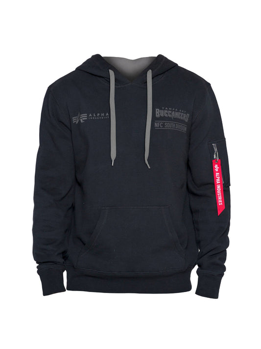 The Tampa Bay Buccaneers X Alpha Industries X New Era Hoodie by Alpha Industries comes in black and features a gray hood lining along with a front logo that reads "Alpha," celebrating the Tampa Bay Buccaneers NFC South Division. The hoodie includes unique flight tag branding, with the red zipper pull on the sleeve labeled "Remove Before Flight," highlighting the signature Alpha Industries x New Era style.