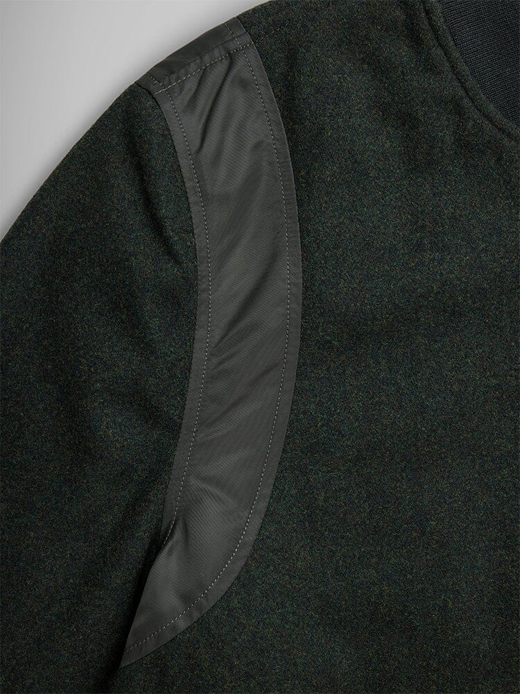 Alpha Industries Wool Varsity Bomber Jacket Gen II, dark green sleeve, curved shiny patch on shoulder, quilted nylon.