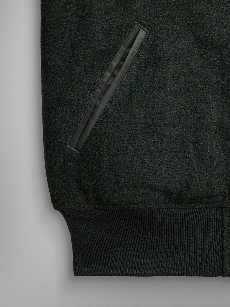 Alpha Industries Wool Varsity Bomber Jacket Gen Ii in dark green, slanted front pocket with leather trim, ribbed hem, nylon quilting.