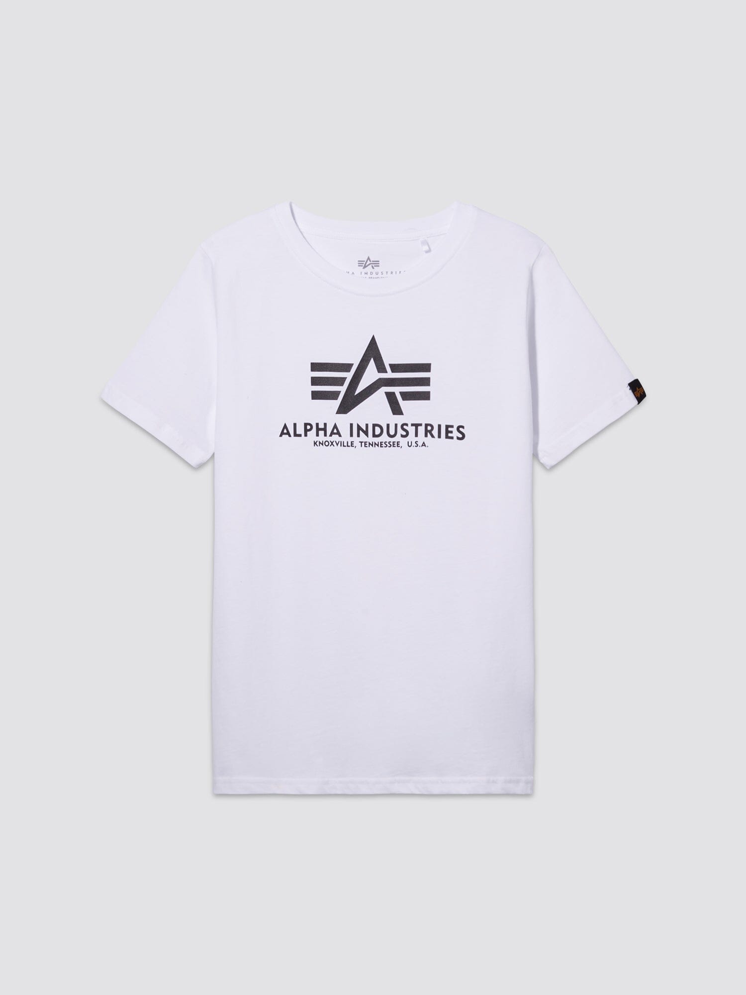 Youth Basic Tee by Alpha Industries, white short-sleeve cotton shirt with flag logo and Alpha Industries, Knoxville, Tennessee, U.S.A. in black on front.